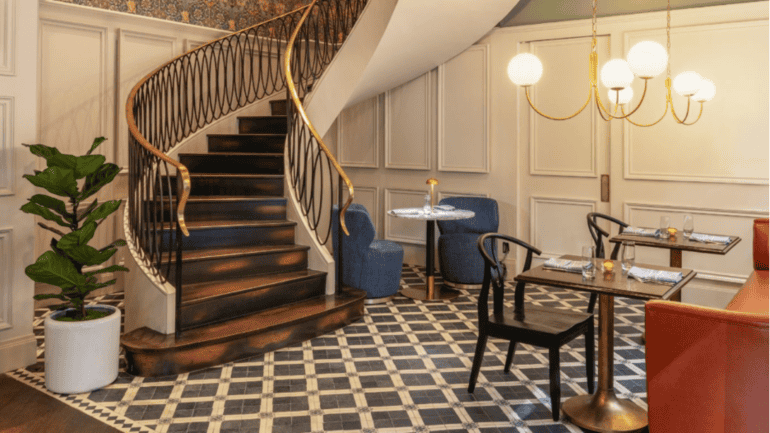 The restaurant features a spiral staircase, elegantly designed, enhancing the ambiance of the space.